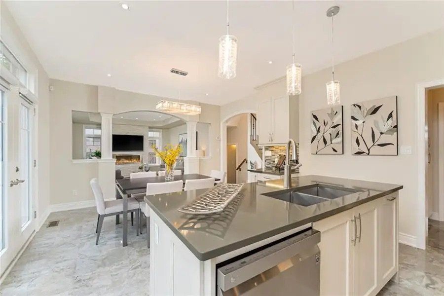 A kitchen with a large island , sink , and dishwasher.