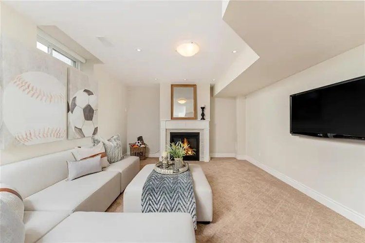 A living room with a fireplace and a flat screen tv