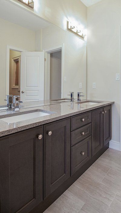 A bathroom with two sinks and a large mirror.