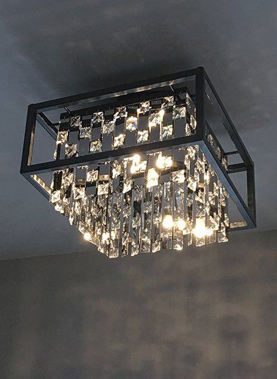 A ceiling light with a lot of crystals on it