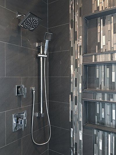 A close up of a shower head in a bathroom.