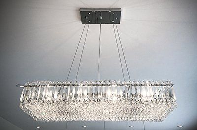A large crystal chandelier is hanging from the ceiling in a room.
