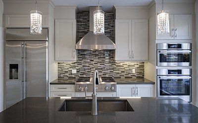 A kitchen with stainless steel appliances and a sink.