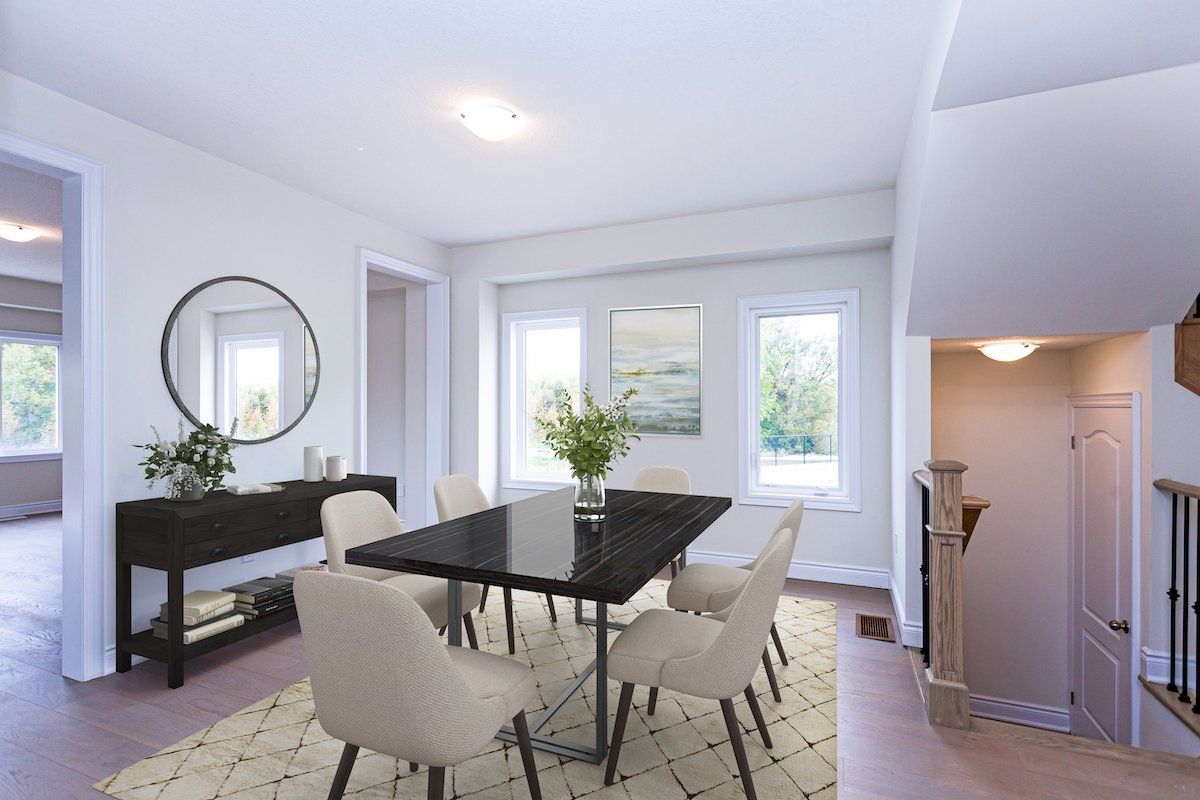 A dining room with a table and chairs and a mirror.