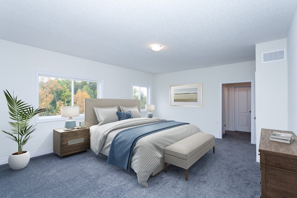 A bedroom with a bed , dresser , nightstand and window.