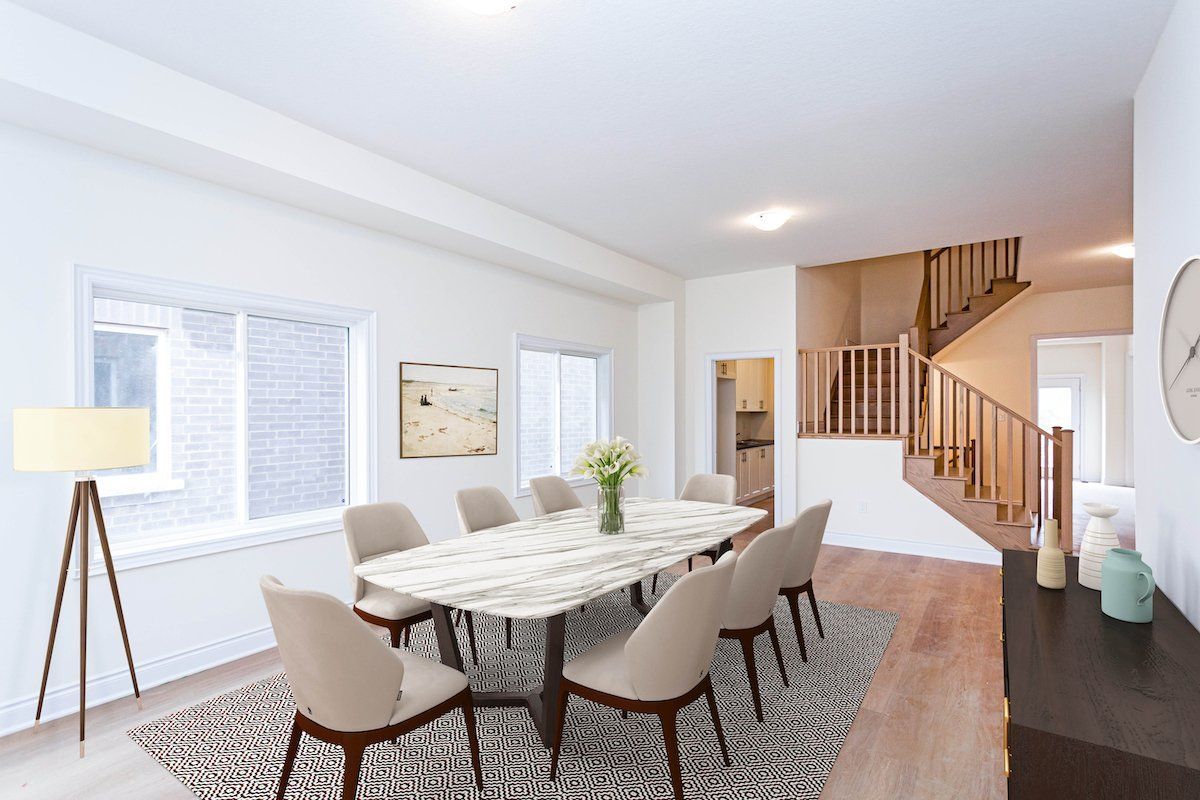 A dining room with a table and chairs and a staircase.