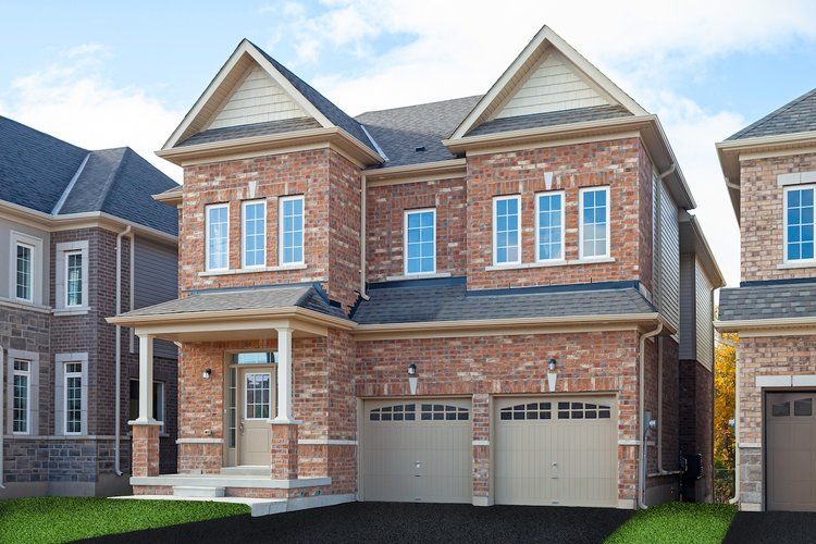 A large brick house with two garages and a porch