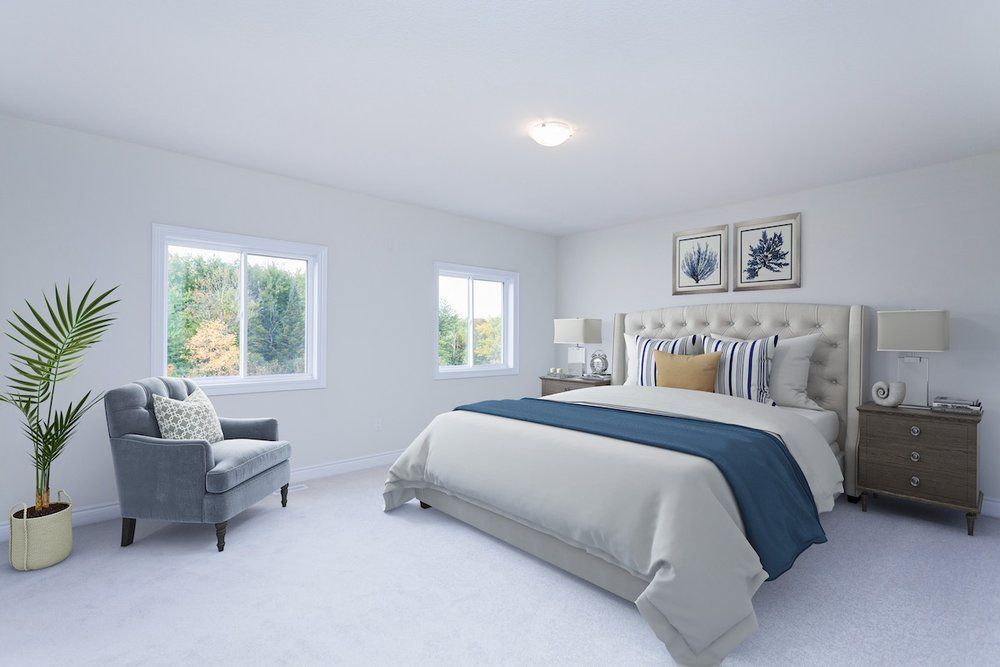 A bedroom with a bed , chair , nightstand and window.