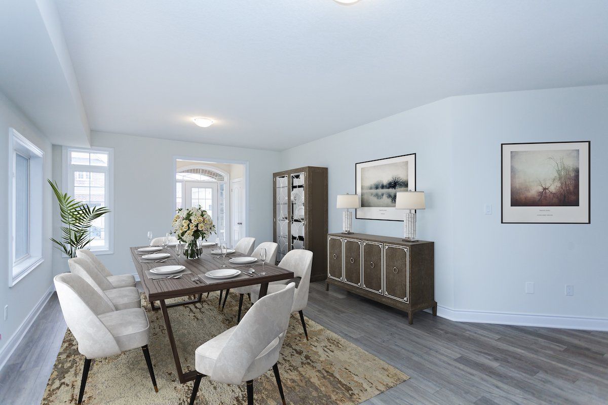 A dining room with a table and chairs and a rug