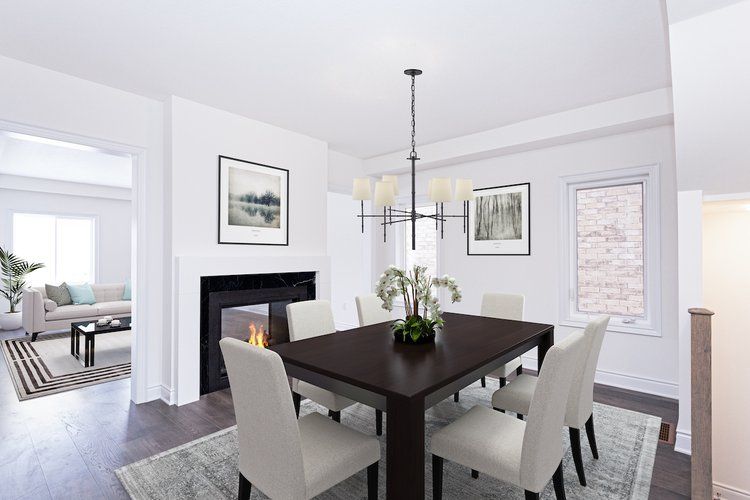 A dining room with a table and chairs and a fireplace.
