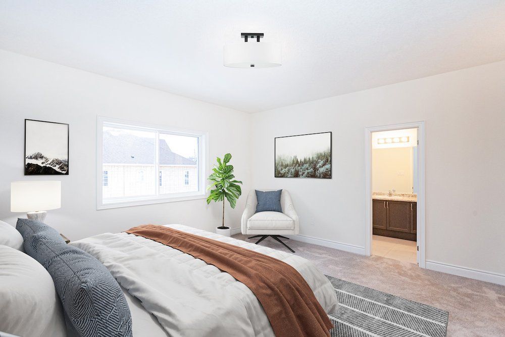 A bedroom with a large bed , chair , and window.