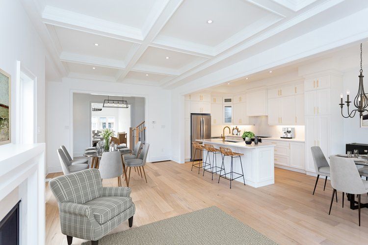 A living room filled with furniture and a kitchen with a large island.