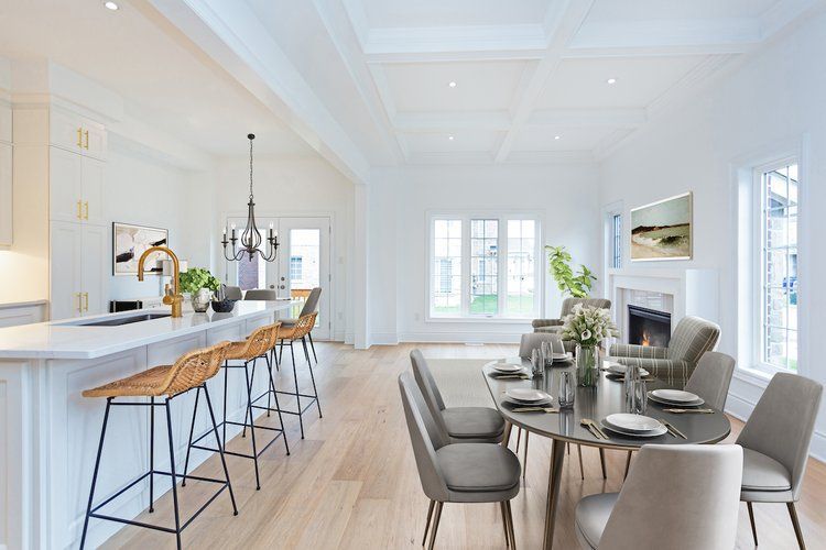 A kitchen and dining room in a house with a table and chairs.
