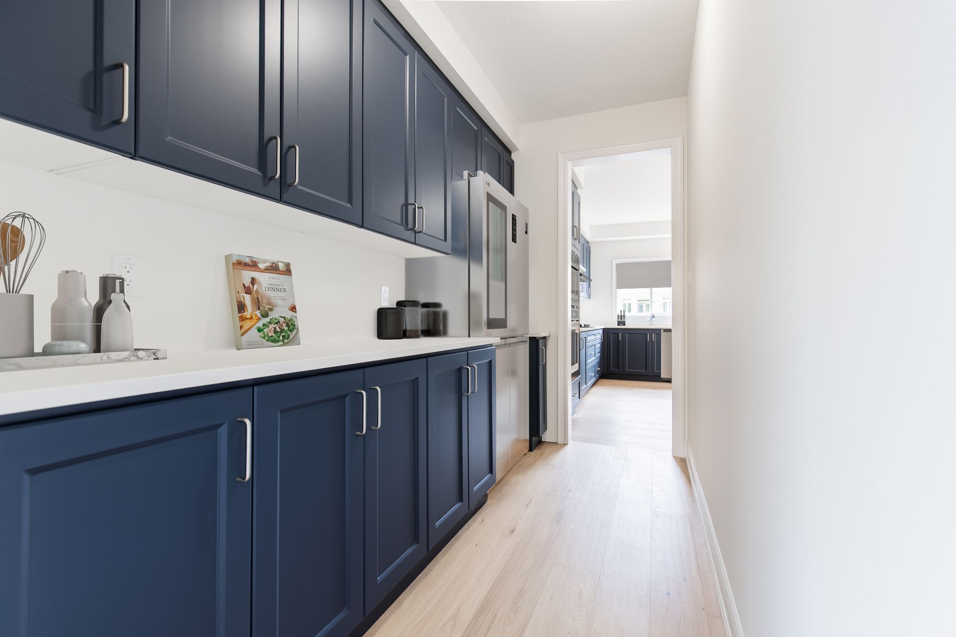 Butler's pantry with navy blue cabinets, white countertops, and a stainless steel refrigerator.