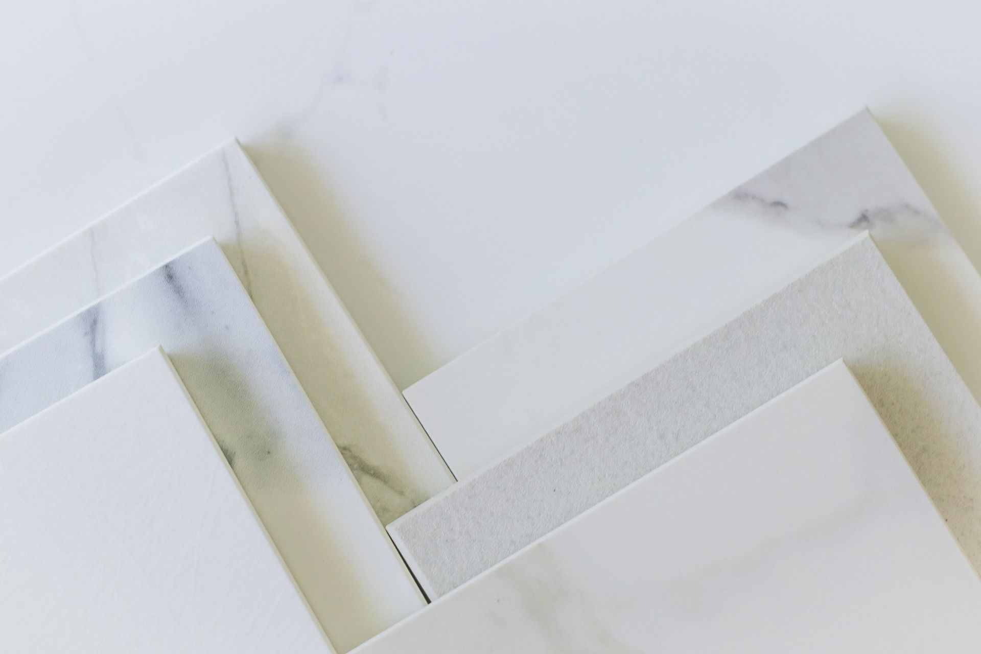 A close up of a stack of white tiles on a table.