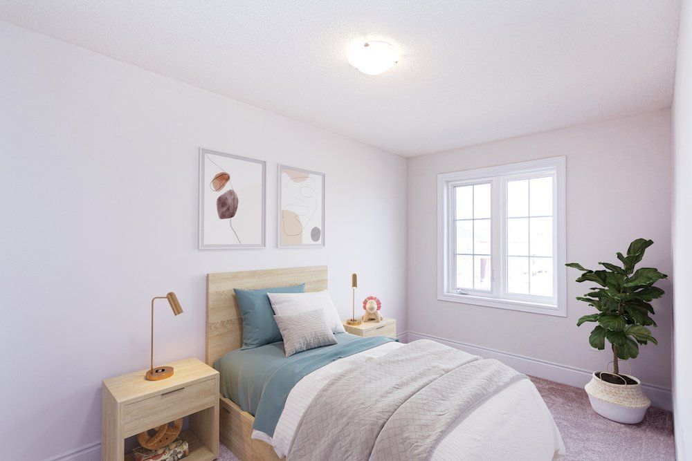 A bedroom with a bed , nightstand , lamp and window.