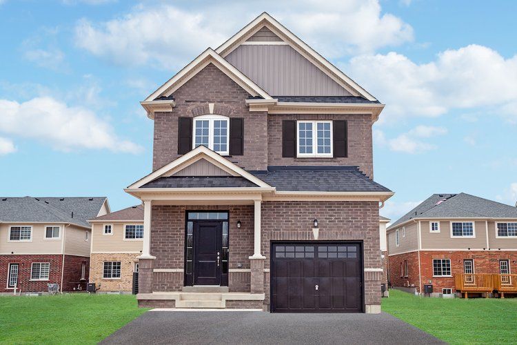 A large brick house with a black garage door