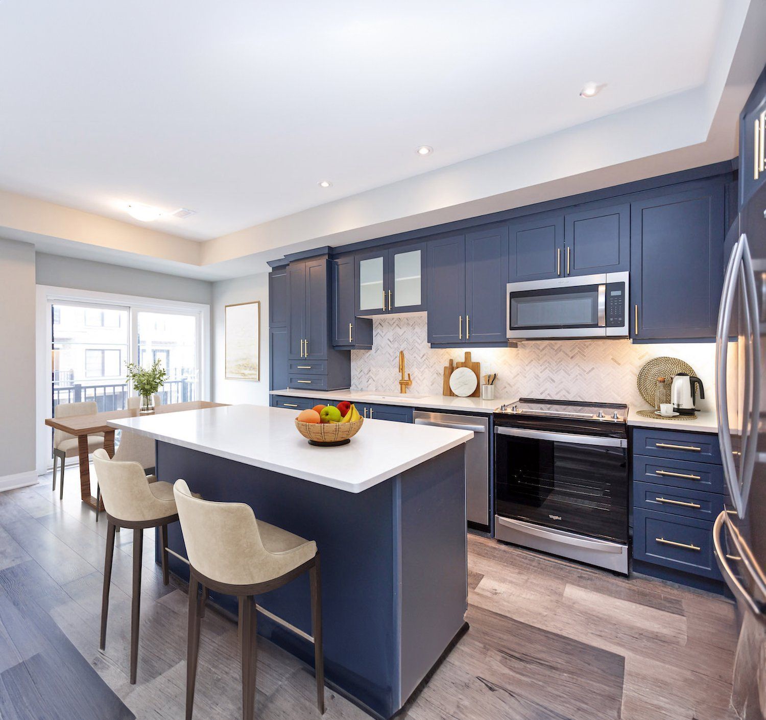 A kitchen with blue cabinets and stainless steel appliances