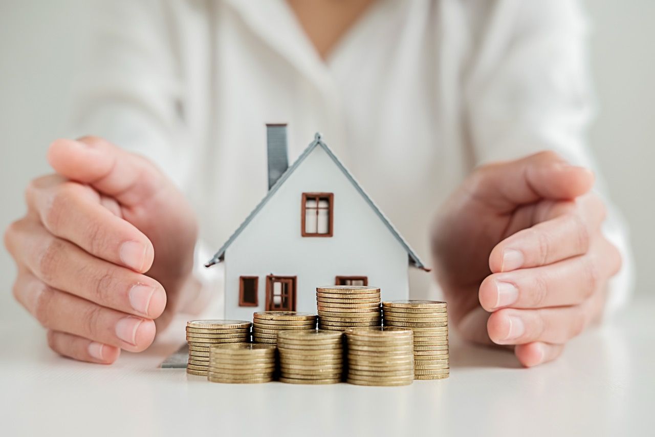 concept image of a house with money in front illustrating the process of preparing to close your home financially 