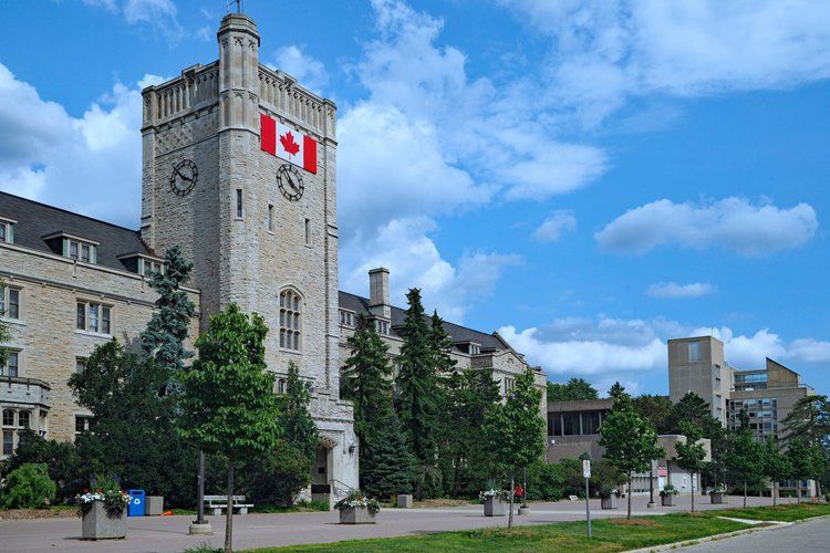 A clock tower with a canadian flag on it