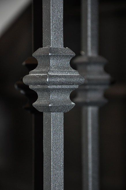 A close up of a metal railing on a staircase.