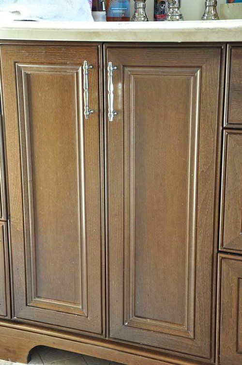 A bathroom vanity with wooden cabinets and drawers