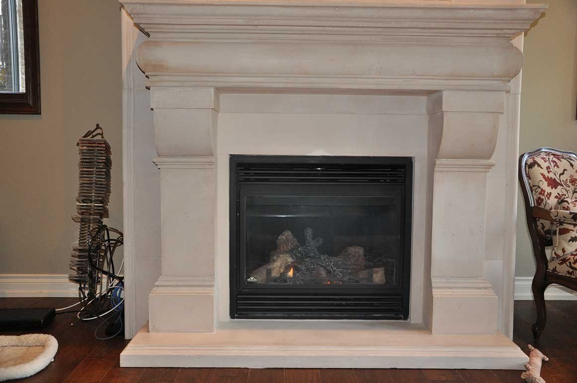 A fireplace is sitting in a living room next to a chair.