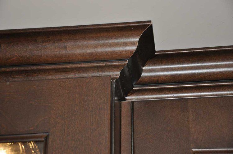 A close up of a wooden door with a molding on it