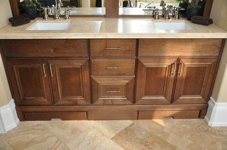 A bathroom vanity with two sinks and a mirror