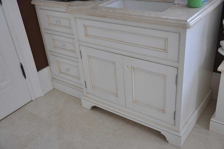 A bathroom vanity with a sink and drawers underneath it.