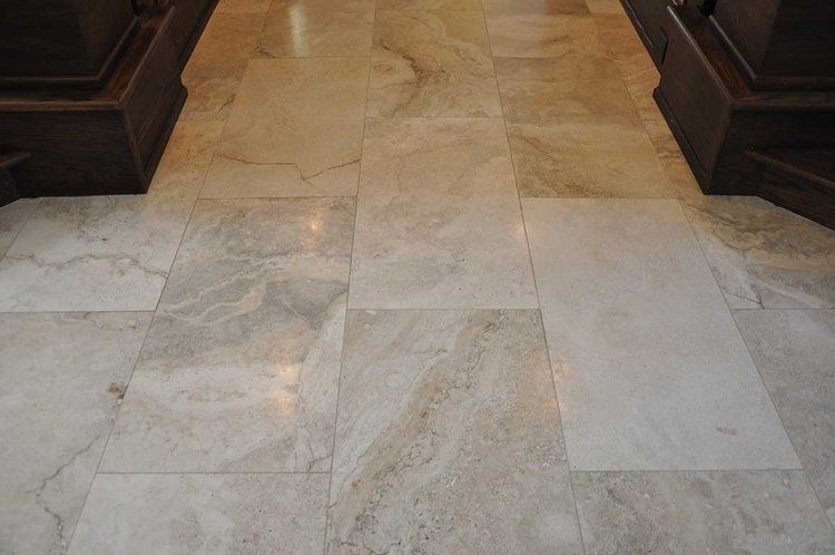 A close up of a marble floor in a hallway.