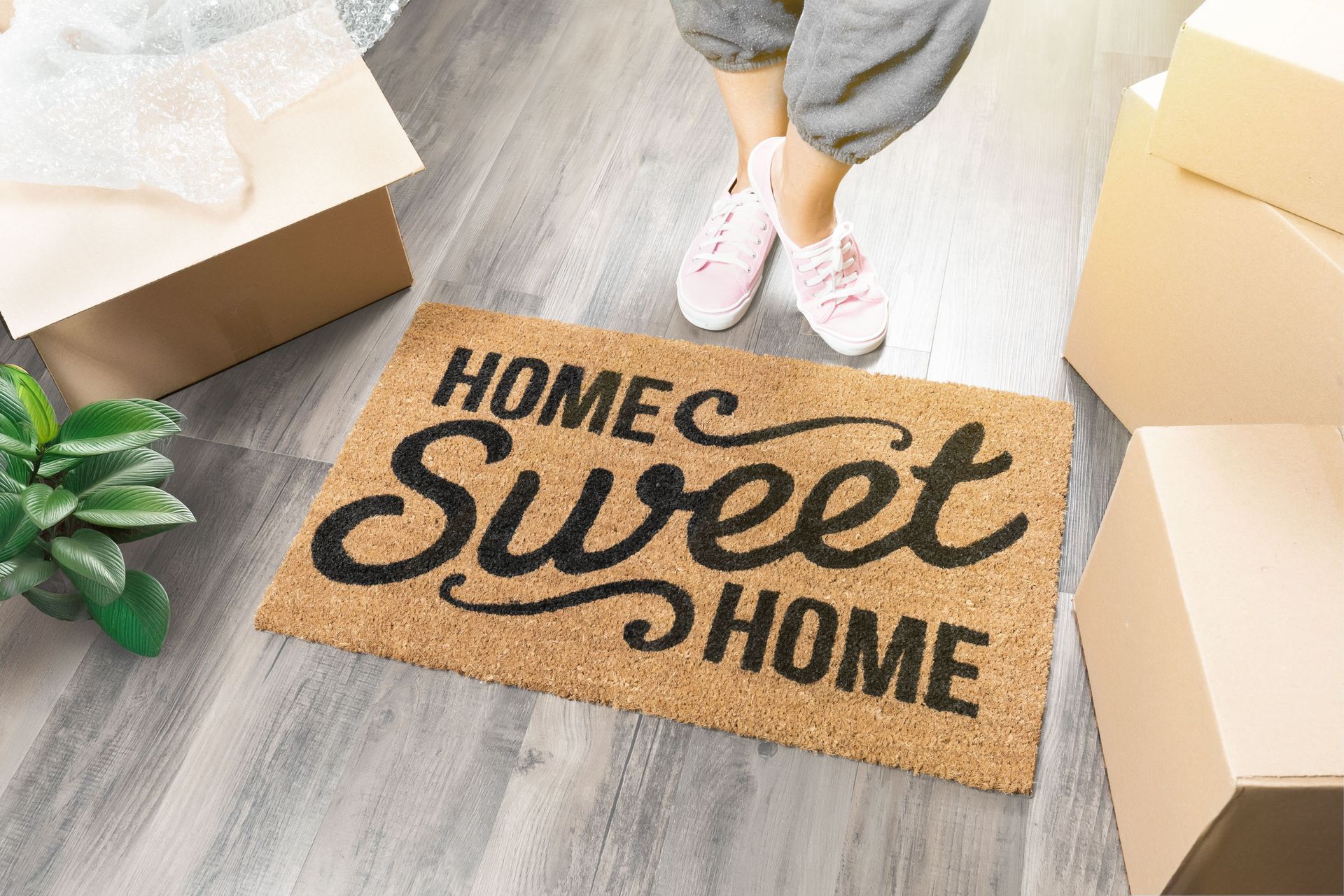 Smiling couple sitting among moving boxes, indoors.
