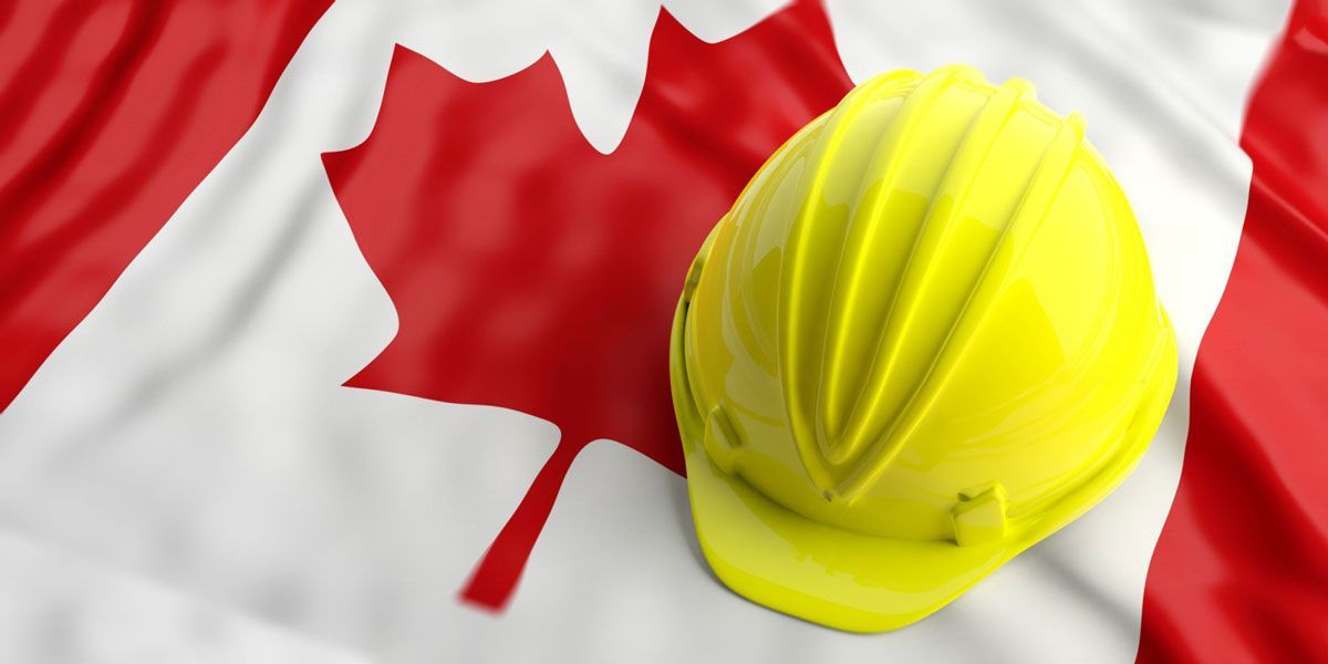 Yellow construction helmet resting on the Canadian flag commemorating Labour day.