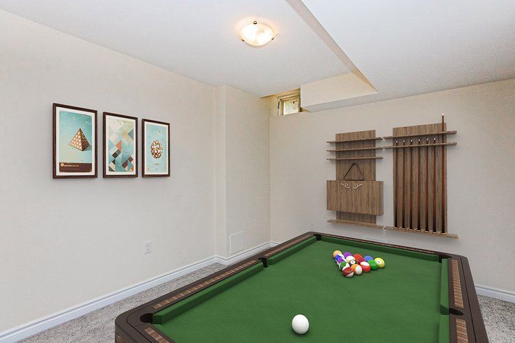 There is a pool table in the middle of the room.