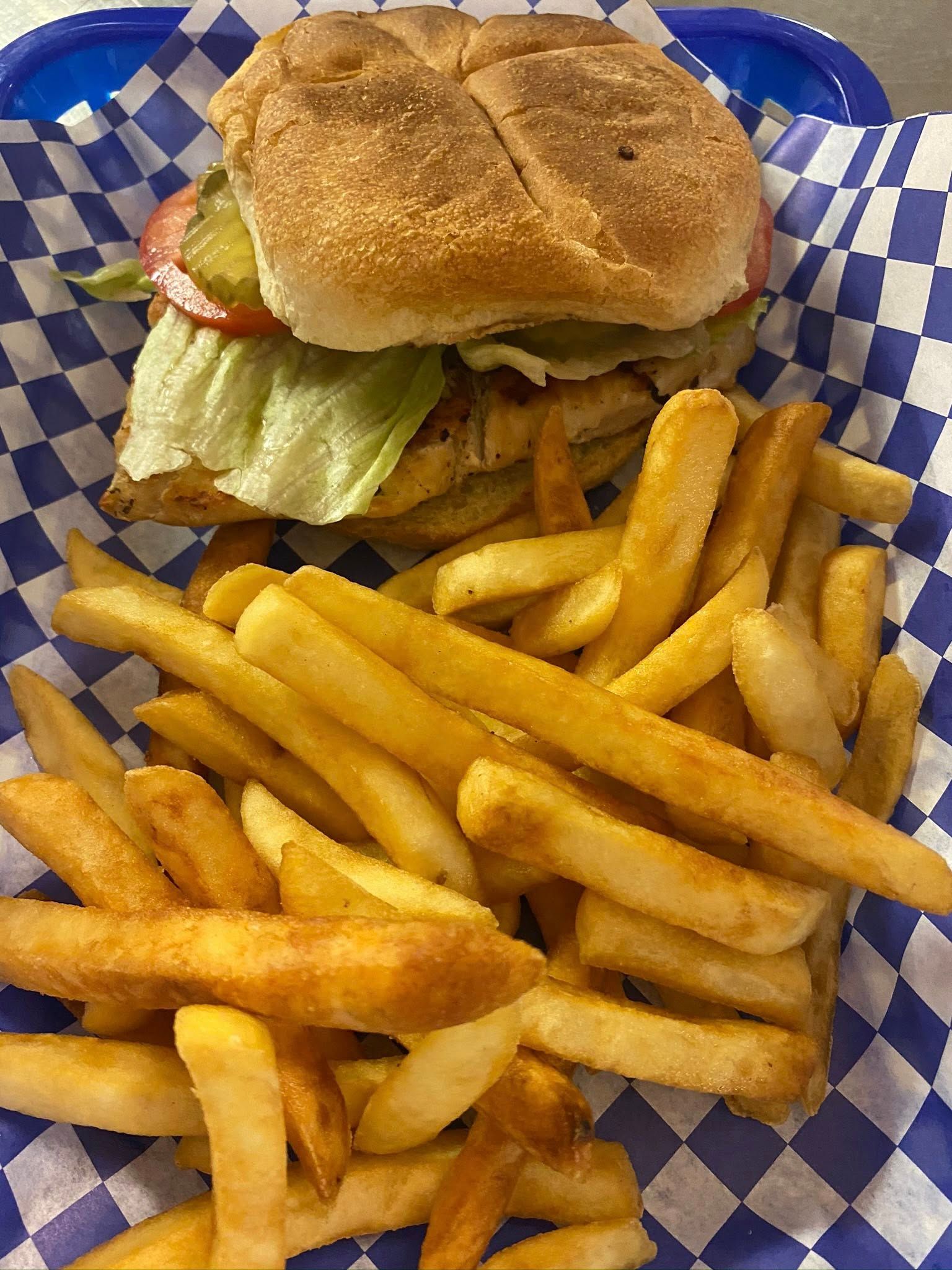 Burger and fries in a blue checkered basket liner