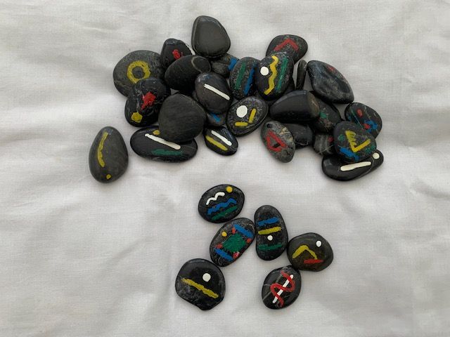 hand-painted symbolic rune stones used in spiritual readings