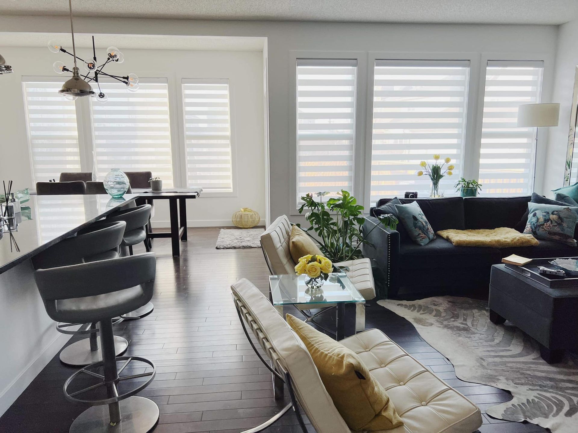 A living room with a couch , chairs , and a table.