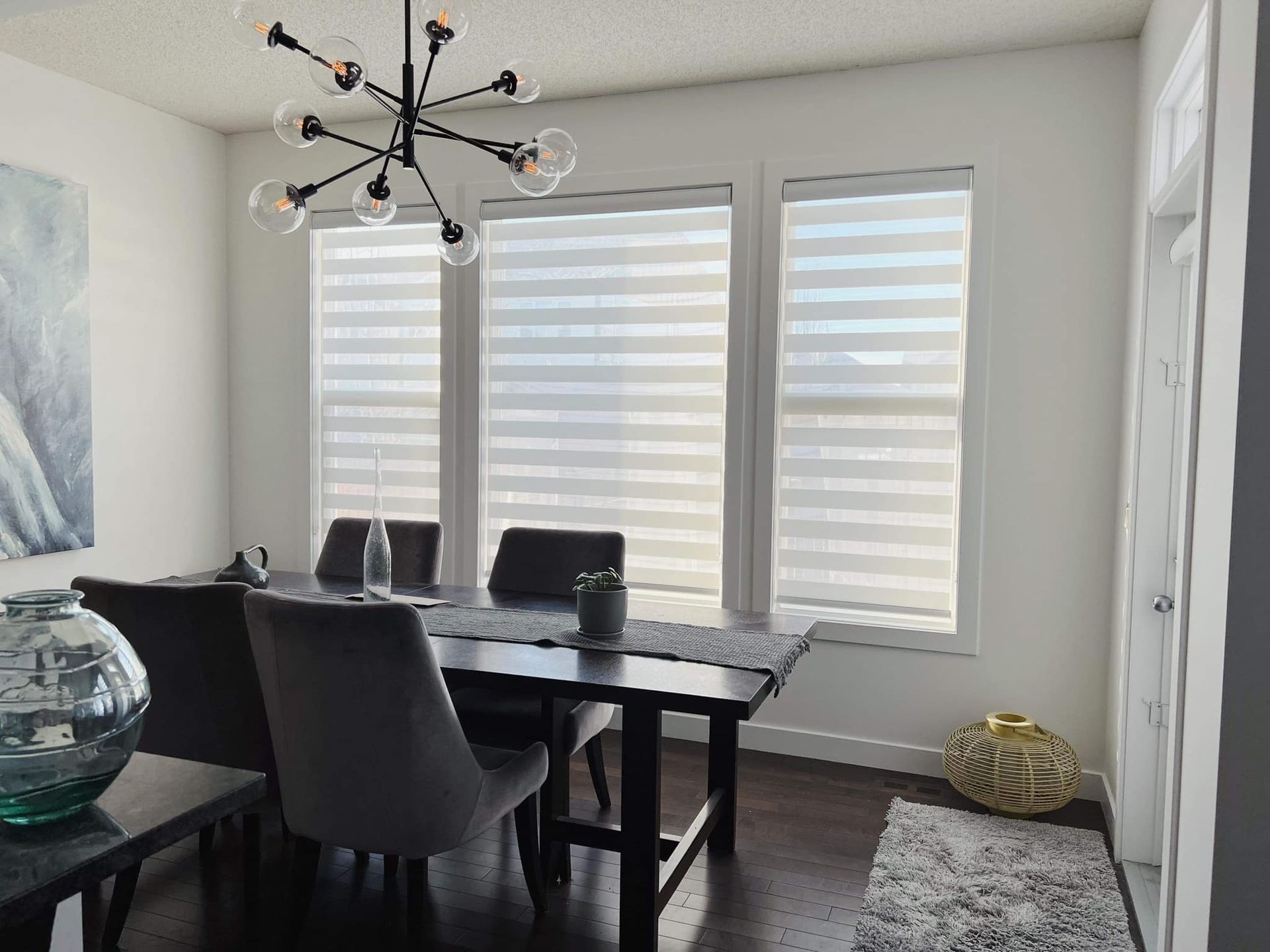 A dining room with a table and chairs and a chandelier.