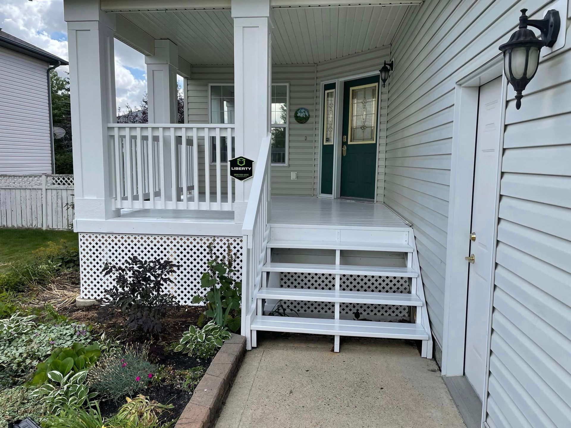 A white house with a porch and stairs