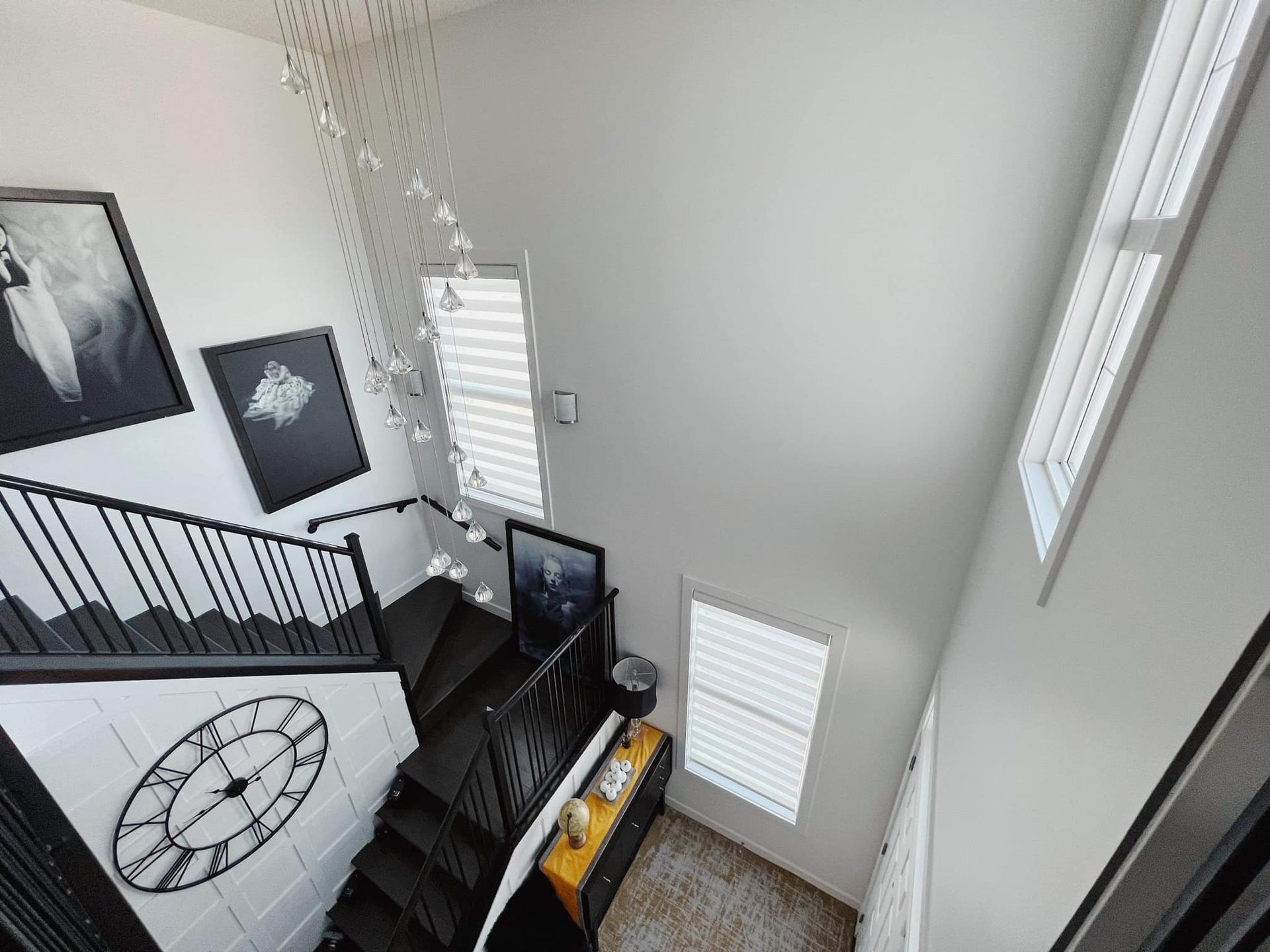 An aerial view of a staircase with a clock on the wall.