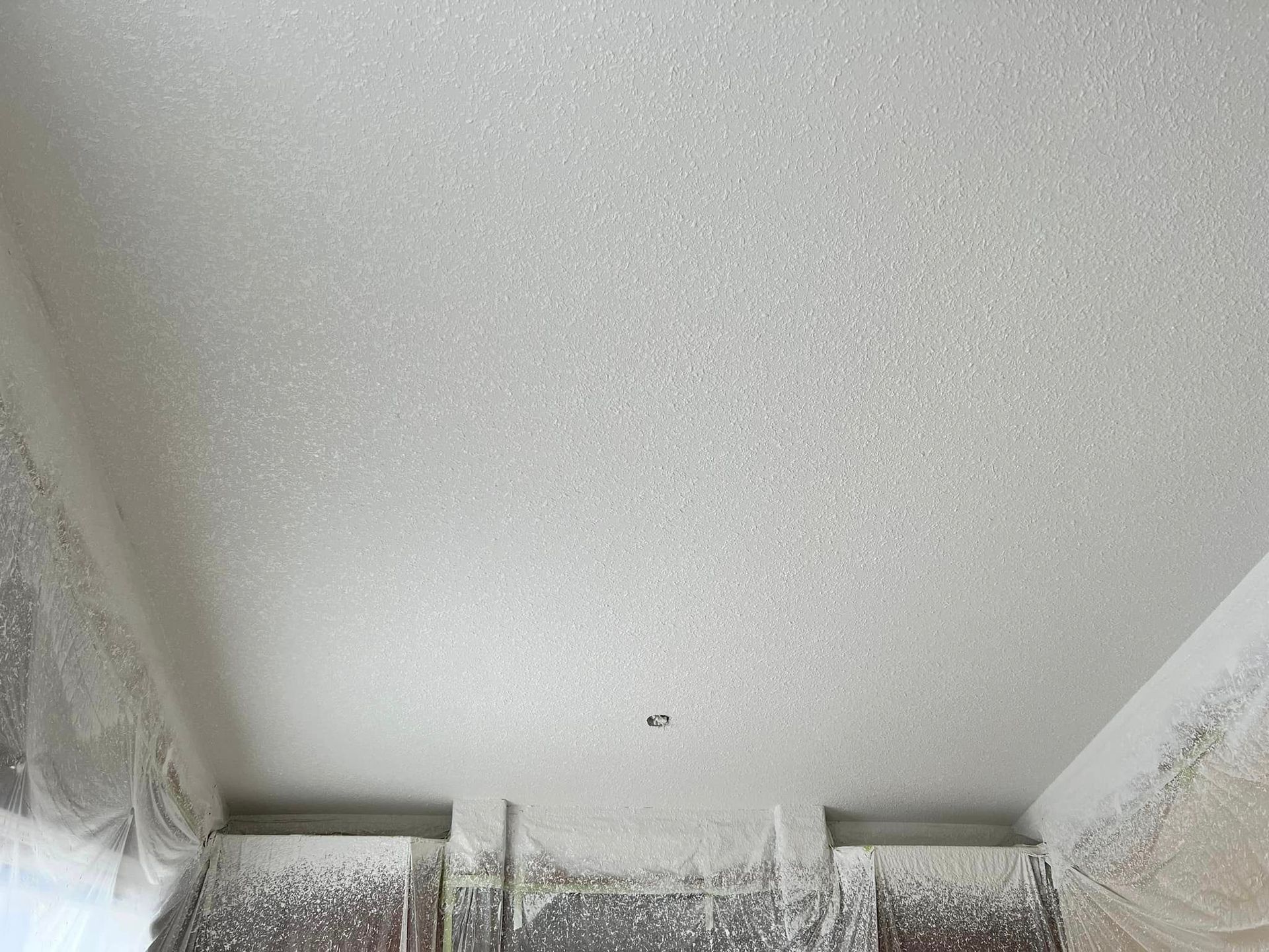 A white ceiling in a room with a lot of dust on it.