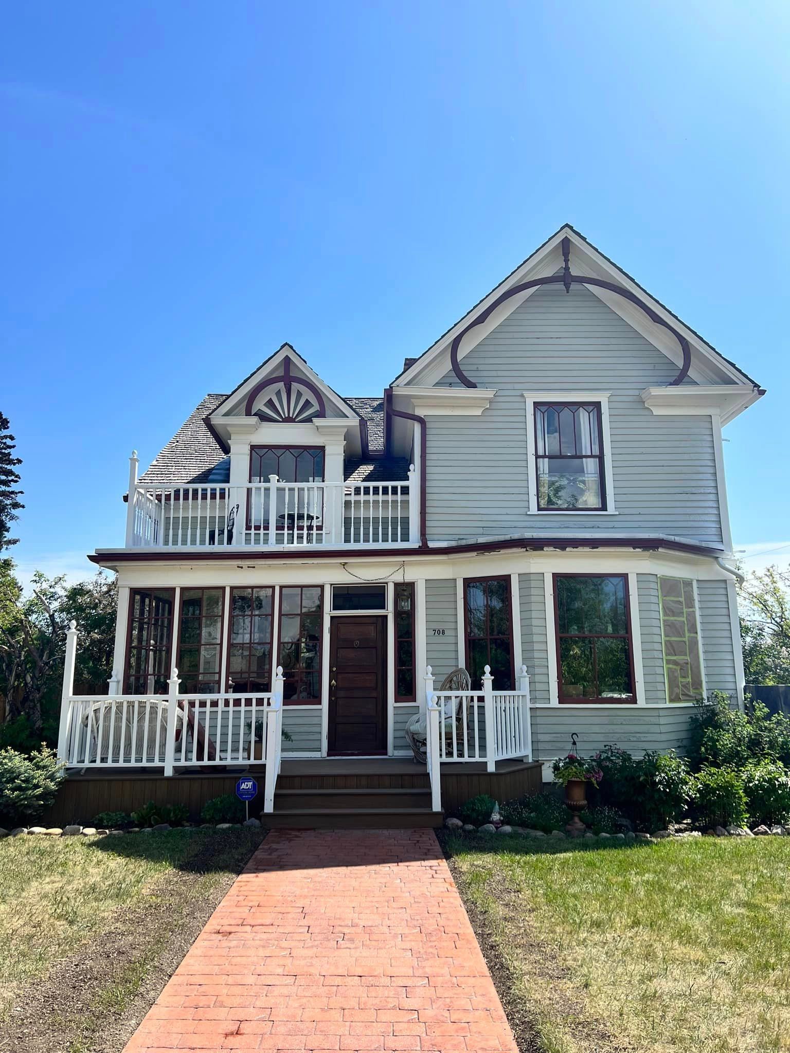 A large house with a brick walkway leading to it