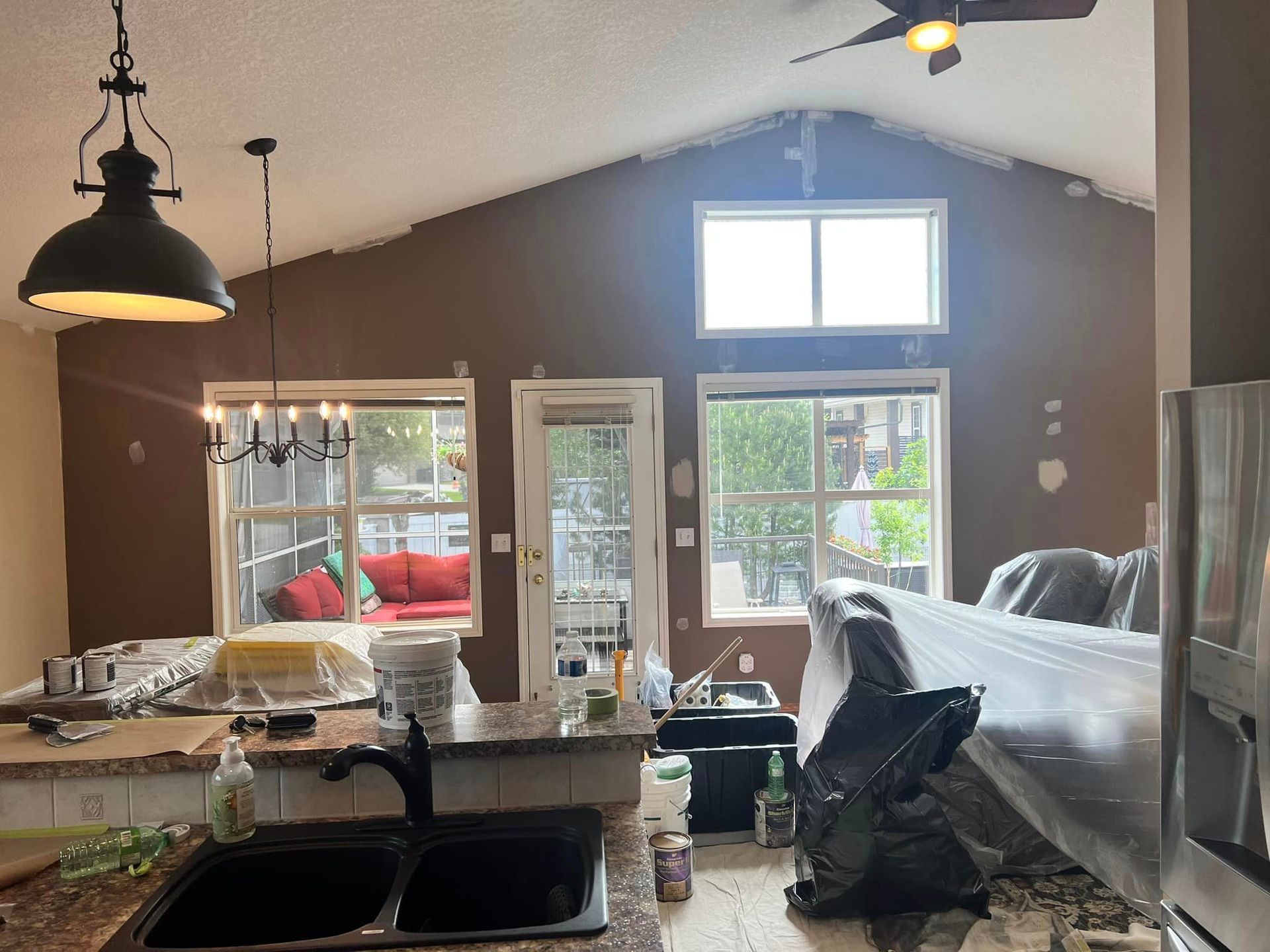 A kitchen with a sink and a ceiling fan.