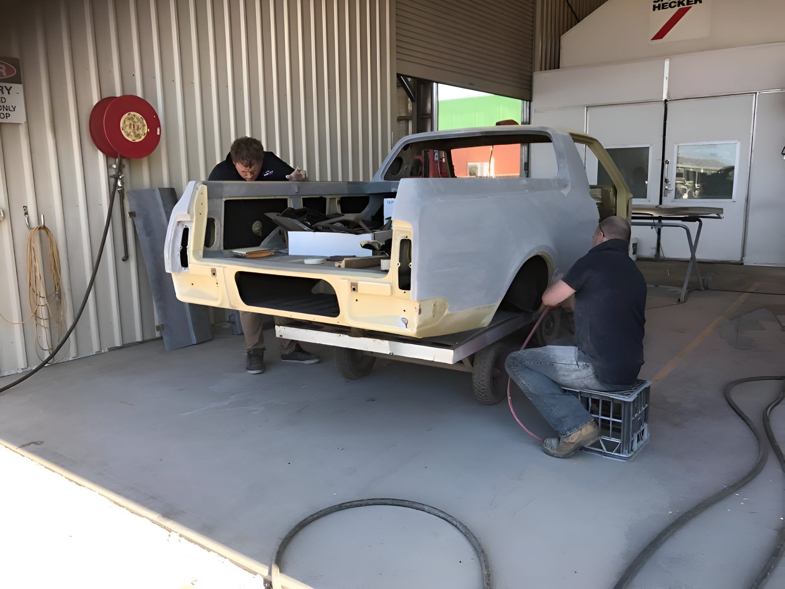 Two Men Are Working On A Truck In A Garage — P & V Panel Works In Alice Springs, NT
