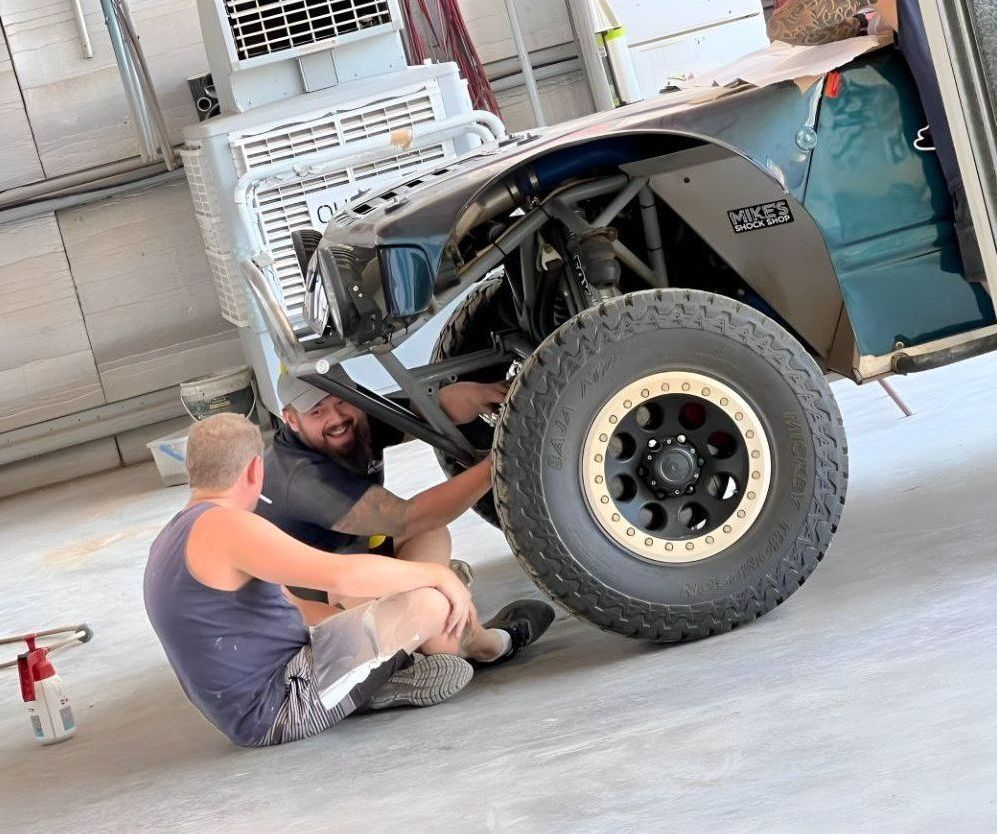 Two Men Are Working On A Jeep In A Garage — P & V Panel Works In Alice Springs, NT