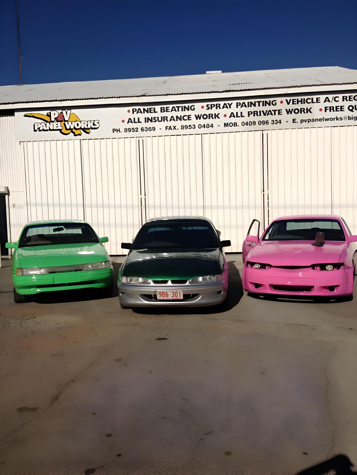Three Cars Are Parked In Front Of A Building That Says Panel Works — P & V Panel Works In Alice Springs, NT
