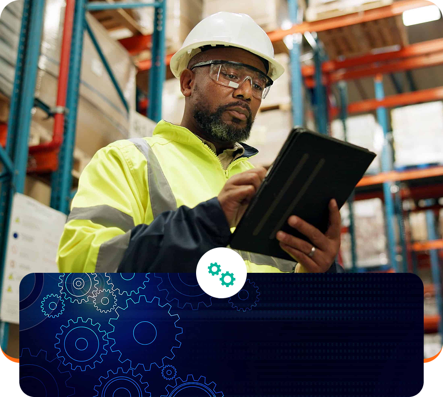 Worker in hard hat and safety vest using a tablet in a warehouse, with a gear-themed digital overlay.