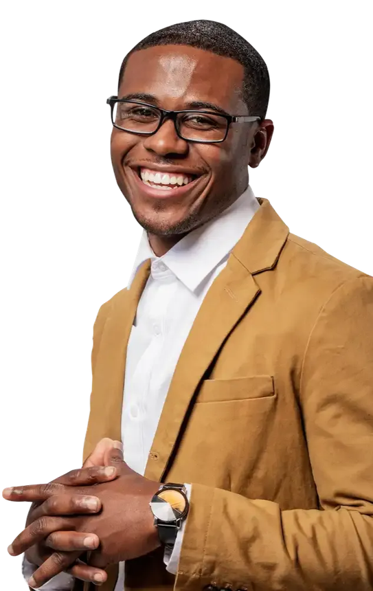 Smiling man in a tan blazer and glasses, hands clasped, against a white background