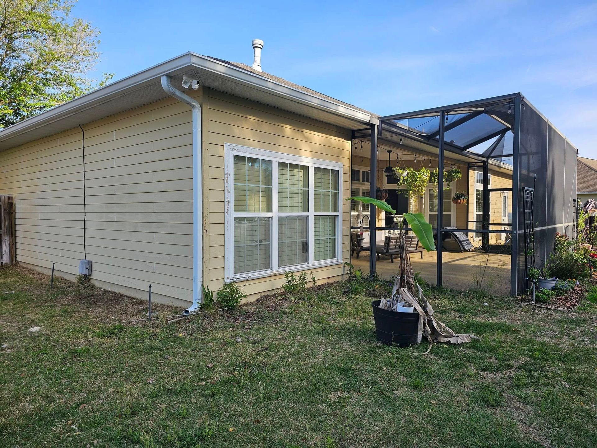 Yellow house with patio screened-in