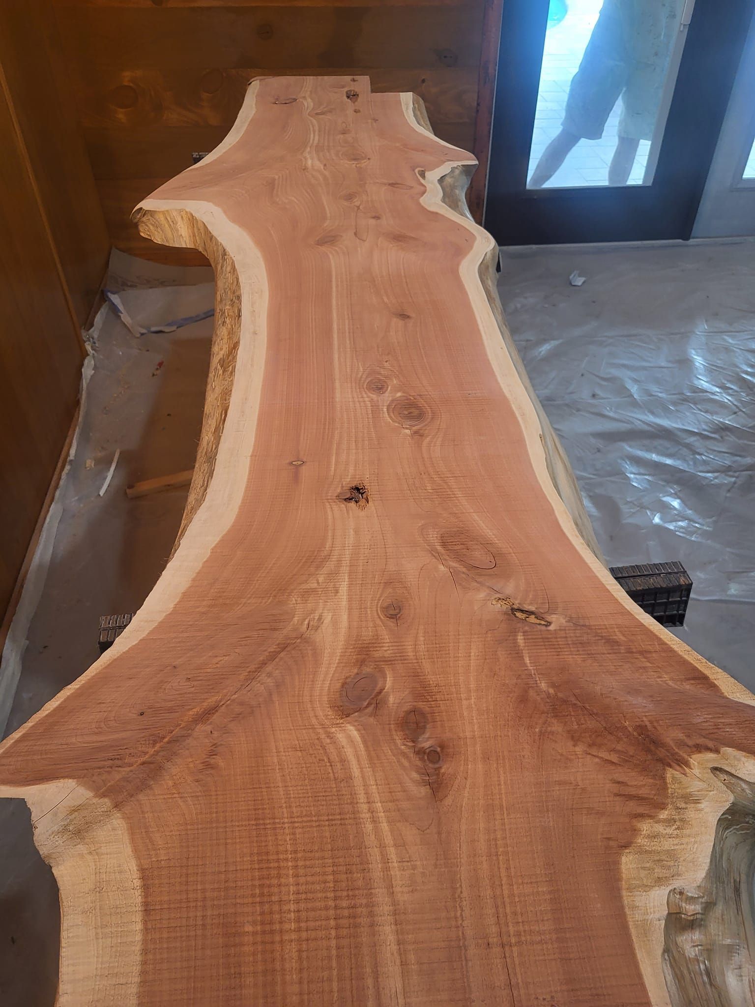 Reddish-brown live edge wood slab with natural edges